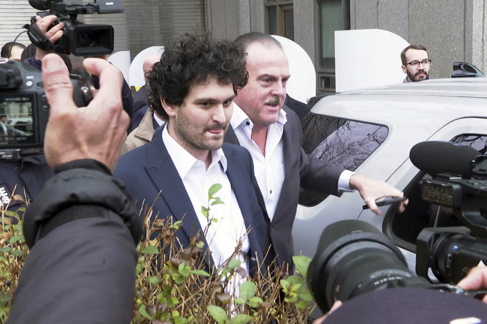 Cryptocurrency entrepreneur Sam Bankman-Fried leaves Manhattan federal court on bail ,Thursday, Dec. 22, 2022 in New York. Bankman-Fried is accused of swindling investors and looting customer deposits on his FTX trading platform. (AP Photo/Ted Shaffrey)