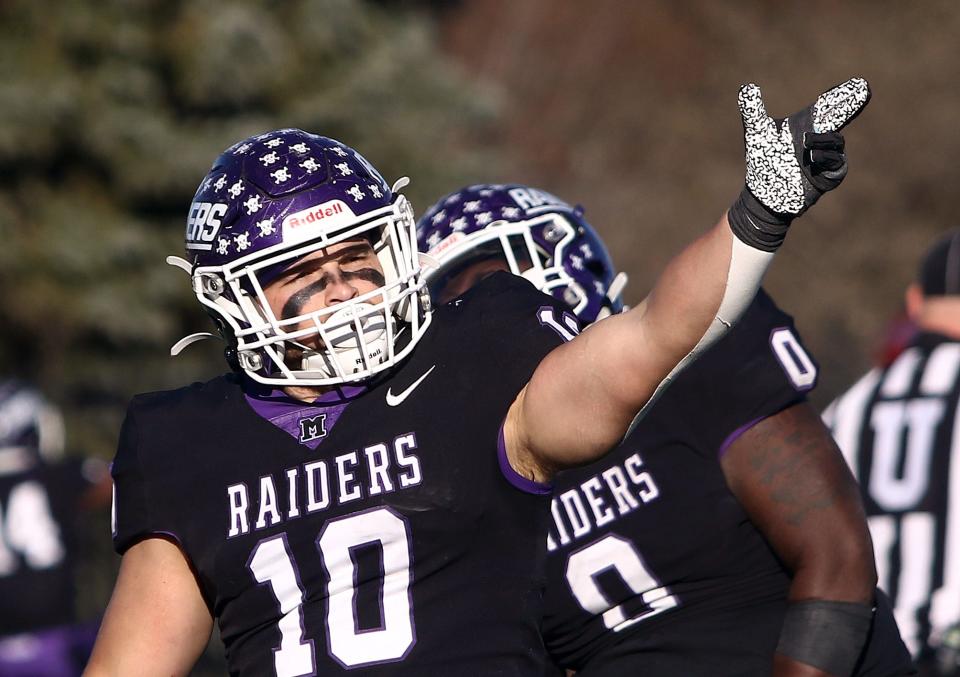 Mount Union defender Eli Beers signals a fourth down stop against Muhlenberg during their quarterfinal playoff game Saturday, December 4, 2021