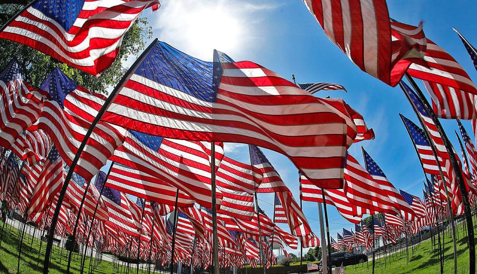 U.S. flags are lined up for Memorial Day at the Fort Square green in Quincy on Tuesday, May 25, 2021.