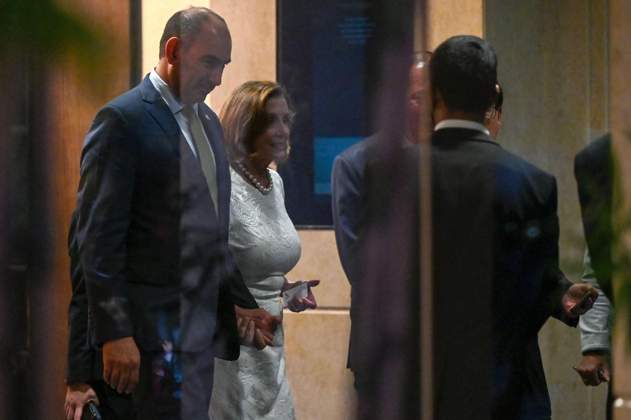 Speaker of the US House of Representatives Nancy Pelosi (2nd L) leaves the Shangri-La Hotel after a reception organised by the American Chamber of Commerce in Singapore on August 1, 2022. 