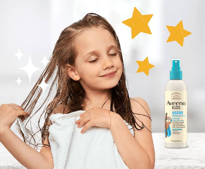 Child drying hair with a towel next to Aveeno Kids Detangling Spray