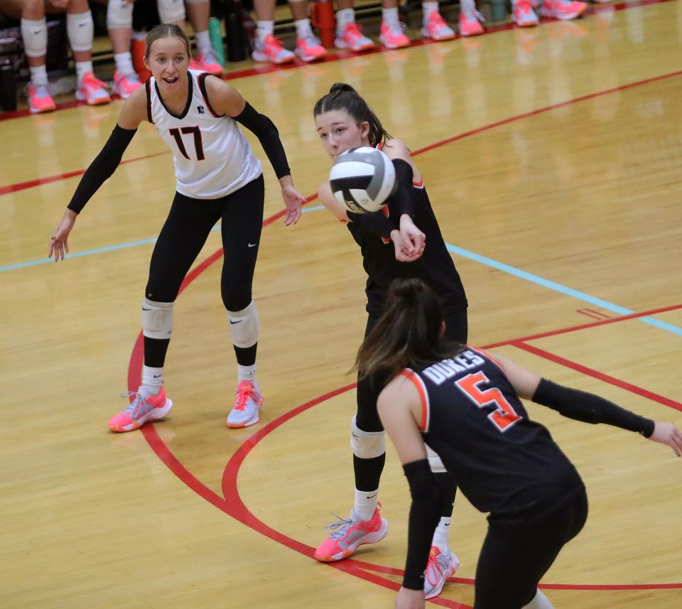 Marlington's Alex Ritchie, center, returns a serve as Jacsyn Hilliard, left, and Claire Battershell look on during their regional final vs. Copley, Nov. 4, 2023.