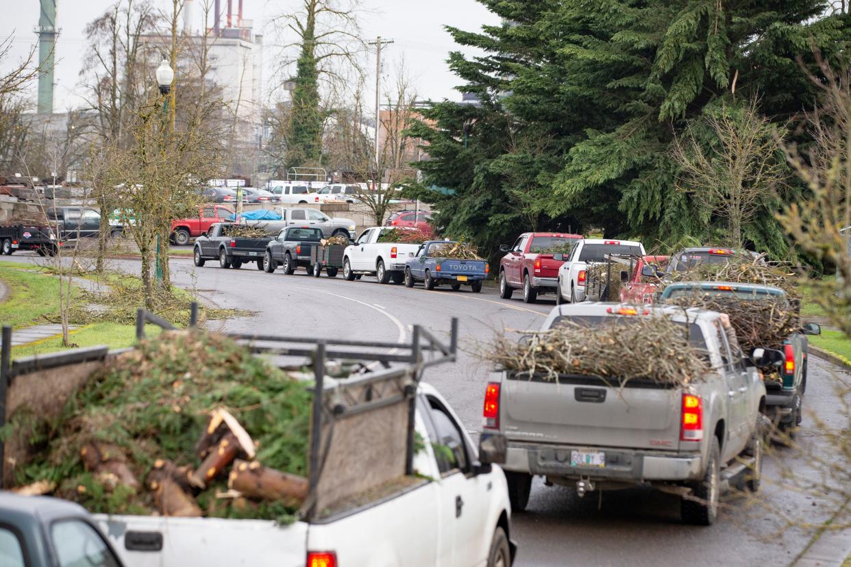 Vehicles wait to drop off storm debris at Lane Forest Products as winter storm recovery continues Jan. 20 in Springfield.