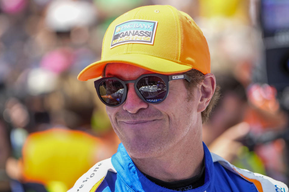 Scott Dixon, of New Zealand, walks to his car before the Indianapolis 500 auto race at Indianapolis Motor Speedway in Indianapolis, Sunday, May 29, 2022. (AP Photo/AJ Mast)