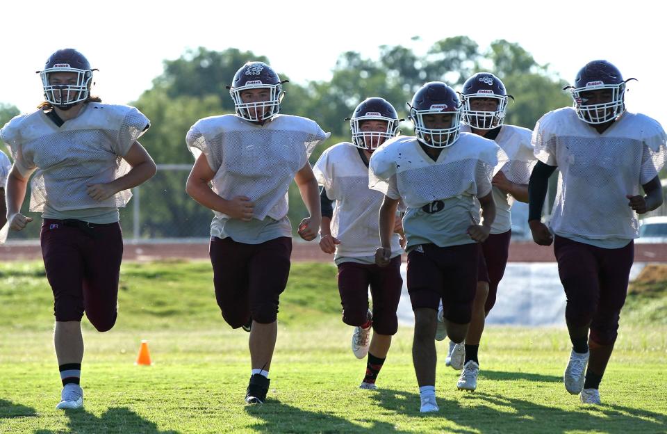 Players on the Paint Rock High School football team run through a practice drill in Paint Rock on Thursday, Aug. 12, 2021.