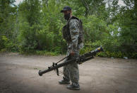 A Ukrainian soldier carries a U.S.-supplied Stinger as he goes along the road, in Ukraine's eastern Donetsk region Saturday, June 18, 2022. (AP Photo/Efrem Lukatsky)