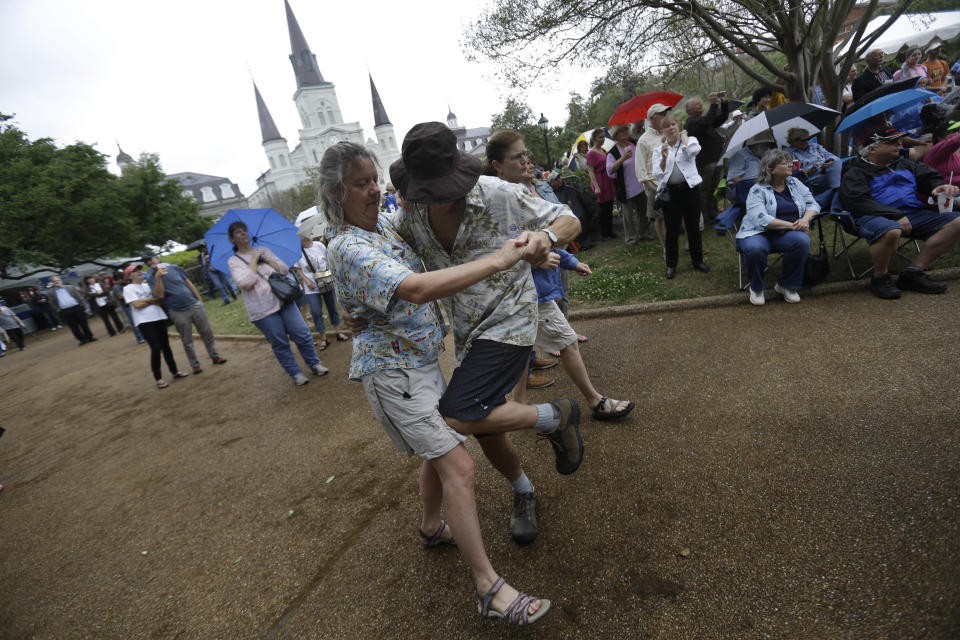 Gretchen Newman and Steven Yesner, of Albequerque, dance to live music on the first day of the annual French Quarter Festival in New Orleans, Thursday, April 11, 2013. French Quarter Festival, which turns 30 this year, runs through Sunday and showcases Louisiana food and music on stages strung throughout the historic neighborhood, including Jackson Square, the French Market, along narrow streets and on the Mississippi riverfront. The lineup includes Irma Thomas, trumpeter Kermit Ruffins, Cajun fiddler Amanda Shaw, the Dirty Dozen Brass Band and about 250 other acts. (AP Photo/Gerald Herbert)