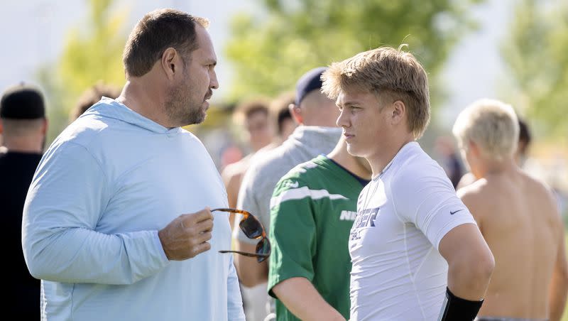 Mike Wilson talks with his son Isaac Wilson during a seven-on-seven passing league game in Layton on Friday, June 9, 2023.