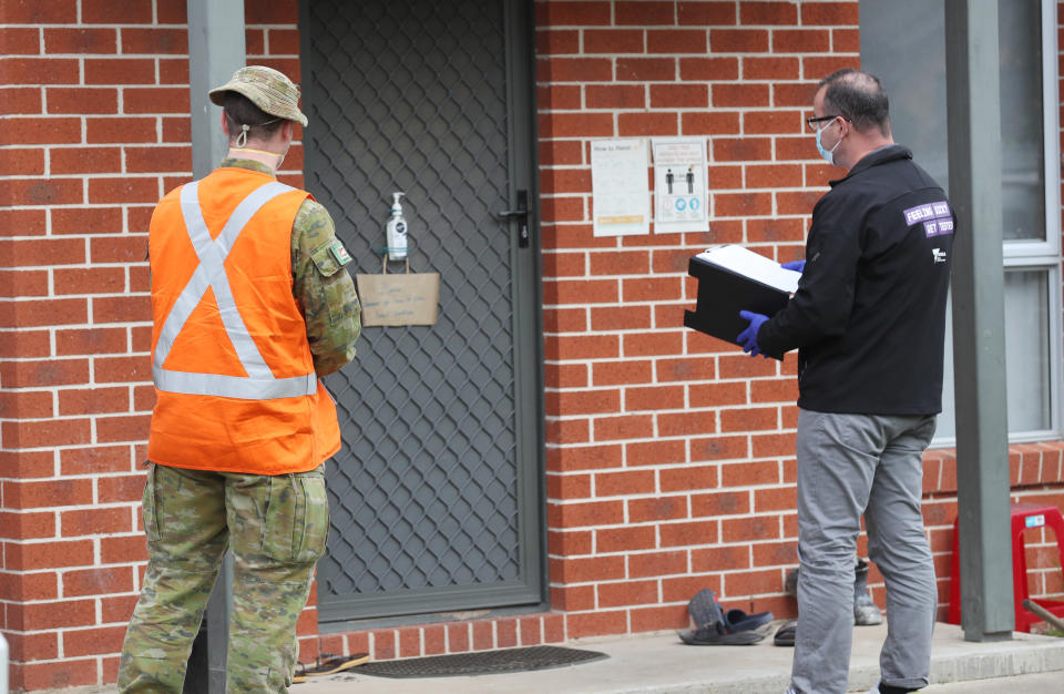 ADF personnel and a Victorian Department of Human Services door knock in Melbourne on Saturday. Source: AAP 