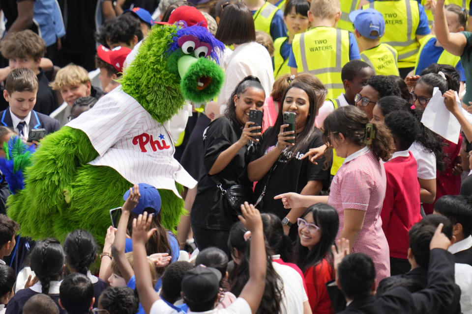 Phillie Phanatic interacts with school children as Philadelphia Phillies train during a workout day at the London Stadium in London, Friday, June 7, 2024. New York Mets will play games against Philadelphia Phillies at the stadium on June 8 and June 9. (AP Photo/Kirsty Wigglesworth)