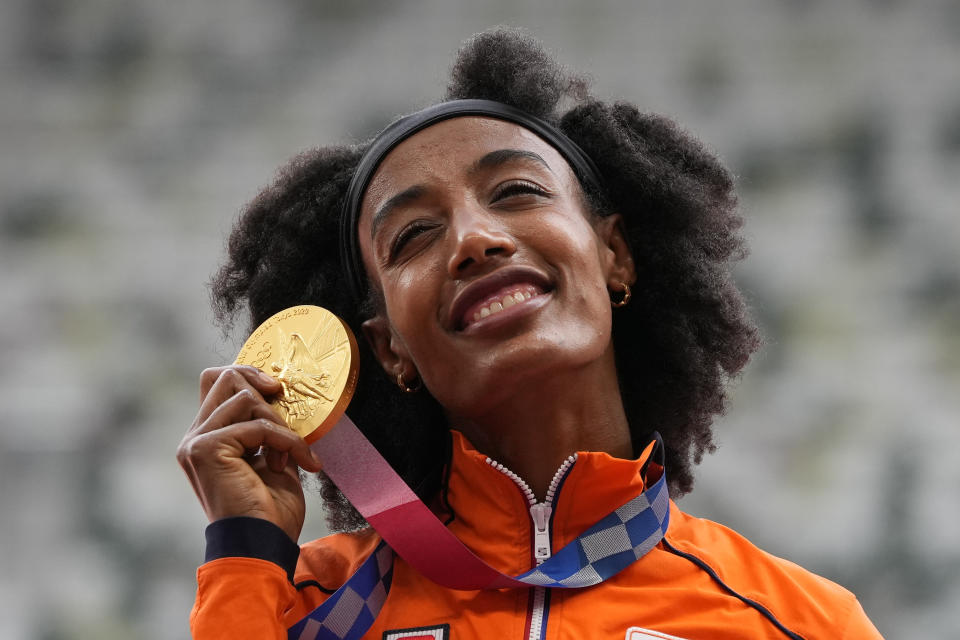 Sifan Hassan, of the Netherlands, holds her gold medal for women's 5,000-meters final at the 2020 Summer Olympics, Tuesday, Aug. 3, 2021, in Tokyo. (AP Photo/Francisco Seco)