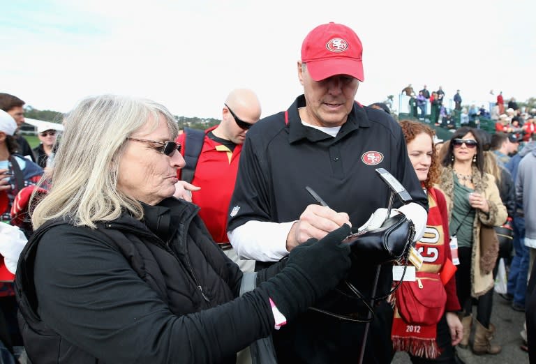 Former San Francisco 49ers wide receiver Dwight Clark signs autographs for fans during the 4th Annual Chevron Charity Shoot-Out at Pebble Beach Golf Links in California, in 2014