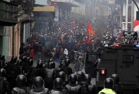 Demonstrators clash with riot police during protests after Ecuador's President Lenin Moreno's government ended four-decade-old fuel subsidies, in Quito