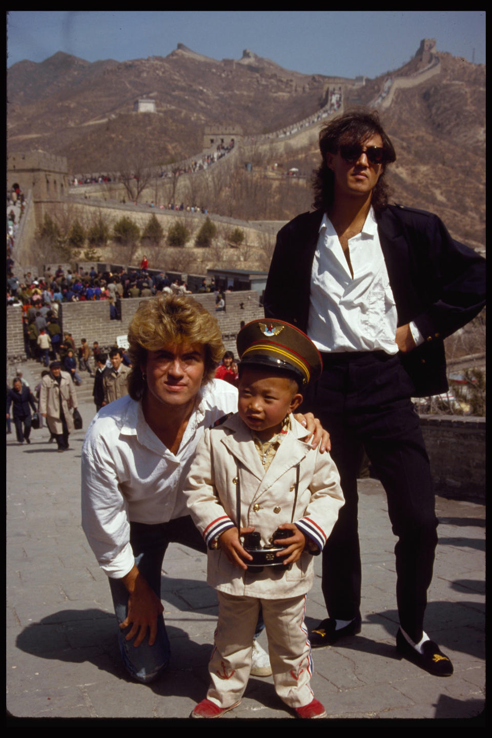 George Michael and Andrew Ridgeley with a local boy at the Great Wall of China. Wham! was the first popular western band to perform in China after the rule of Chairman Mao. (Owen Franken/Corbis via Getty Images)