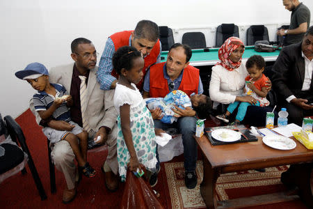 Members of Libyan Red Crescent hand over the children of Sudanese Islamic State members who operated in Libya, to a Sudanese official, in Misrata, Libya August 20, 2017. REUTERS/Ismail Zitouny