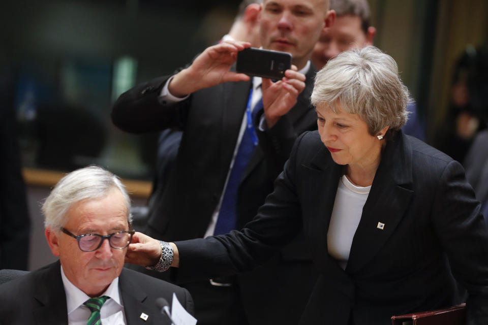 British Prime Minister Theresa May, right, greets European Commission President Jean-Claude Juncker during a round table meeting at an EU summit in Brussels, Thursday, Dec. 13, 2018. EU leaders gathered Thursday for a two-day summit which will center on the Brexit negotiations. (AP Photo/Alastair Grant)