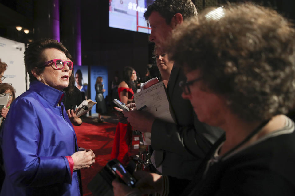 In this Wednesday, Oct. 16, 2019, photo tennis great and founder of Women's Sports Foundation Billie Jean King, left, talks to reporters on the red carpet of the Women's Sports Foundation's 40th annual Salute to Women in Sports in New York. (AP Photo/Mary Altaffer)