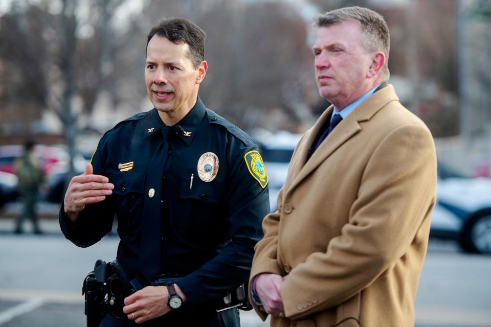 Asheville’s interim Police Chief Mike Lamb, left, speaks to the media following a false alarm downtown in December.