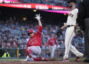 Los Angeles Angels' Andrew Heaney (28) scores on a wild pitch by San Francisco Giants pitcher Alex Wood, right, during the third inning of a baseball game Tuesday, June 1, 2021, in San Francisco. (AP Photo/Tony Avelar)