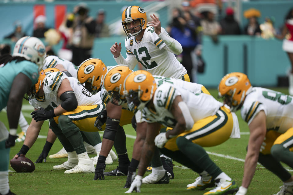 Green Bay Packers quarterback Aaron Rodgers (12) directs his players during the first half of an NFL football game against the Miami Dolphins, Sunday, Dec. 25, 2022, in Miami Gardens, Fla. (AP Photo/Jim Rassol)