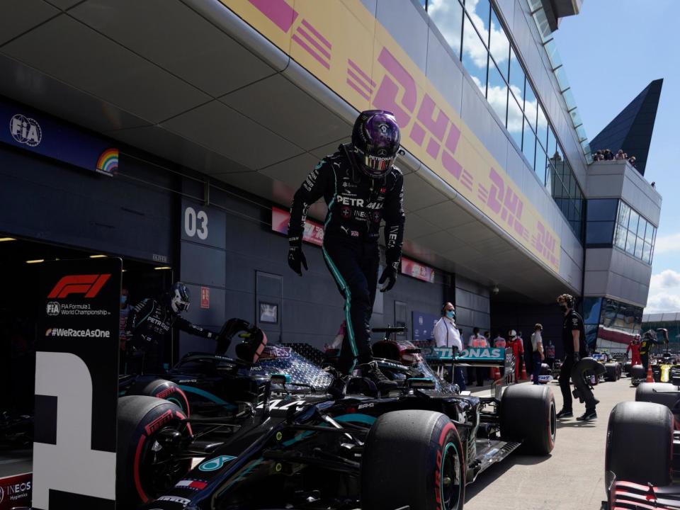 Mercedes' Lewis Hamilton leaves his car after taking pole position at Silverstone: POOL/AFP via Getty Images