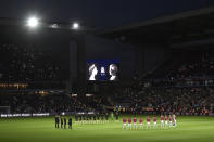 Players stand on the center of the pitch during a moment of silence tribute to Queen Elizabeth II before the English Premier League soccer match between Aston Villa and Southampton at Villa Park in Birmingham, England, Friday, Sept. 16, 2022. (AP Photo/Rui Vieira)