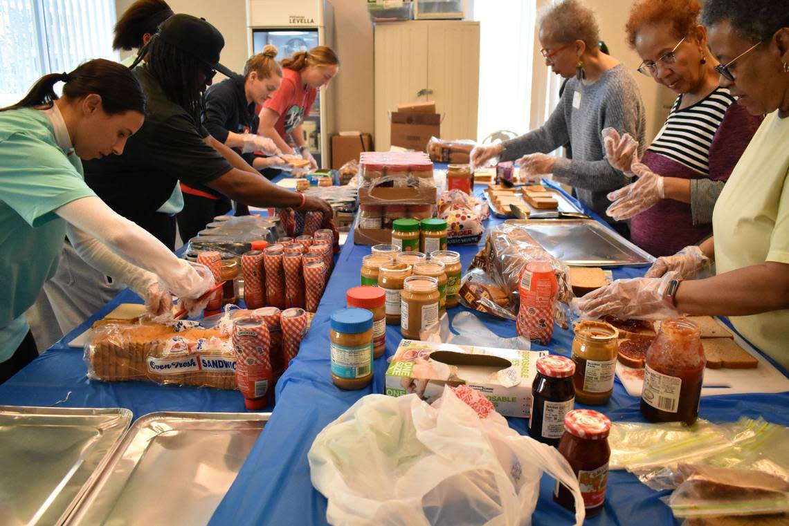 Volunteers, including Kansas City resident Janet Harris, far right, make peanut butter and jelly sandwiches on Martin Luther King Jr. Day at the Linwood YMCA, 3800 E. Linwood Boulevard. The sandwiches will be packed along with other items into care packages for those in need.