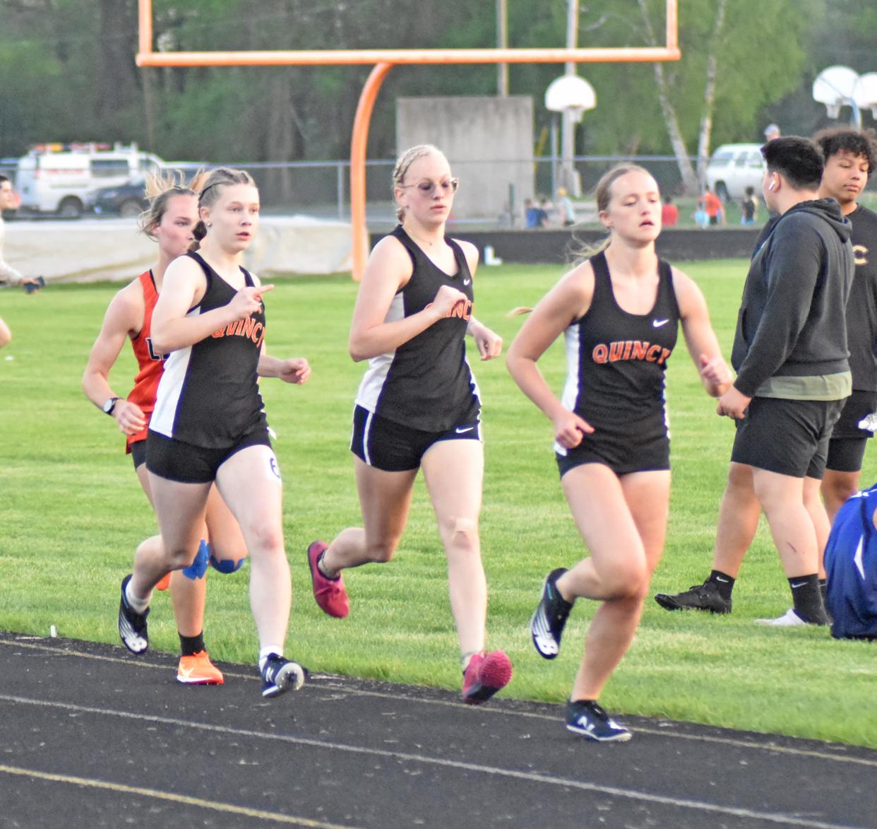 Quincy's trio of Kendyl Musielewicz, Sadie Miller, and Katharina Paschke battle down the back stretch of the 800 meter run on Friday