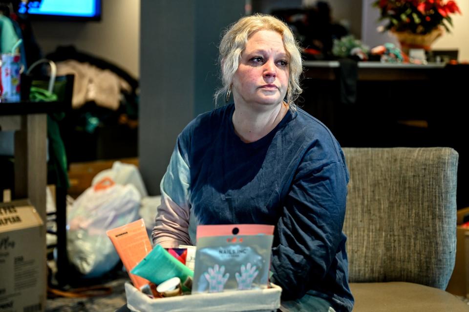 Nikolle Simmon, a resident whose apartment was destroyed in the Knob Hill Apartments fire, sits in the lobby of the Holiday Inn Express on Thursday, Dec. 22, 2022, in Okemos.