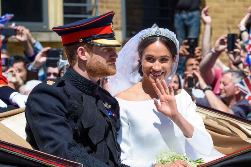 Prince Harry and Meghan Markle, the new Duke and Duchess of Sussex, pictured during their carriage procession through Windsor after the royal wedding on Saturday. (Photo: Empics Entertainment)