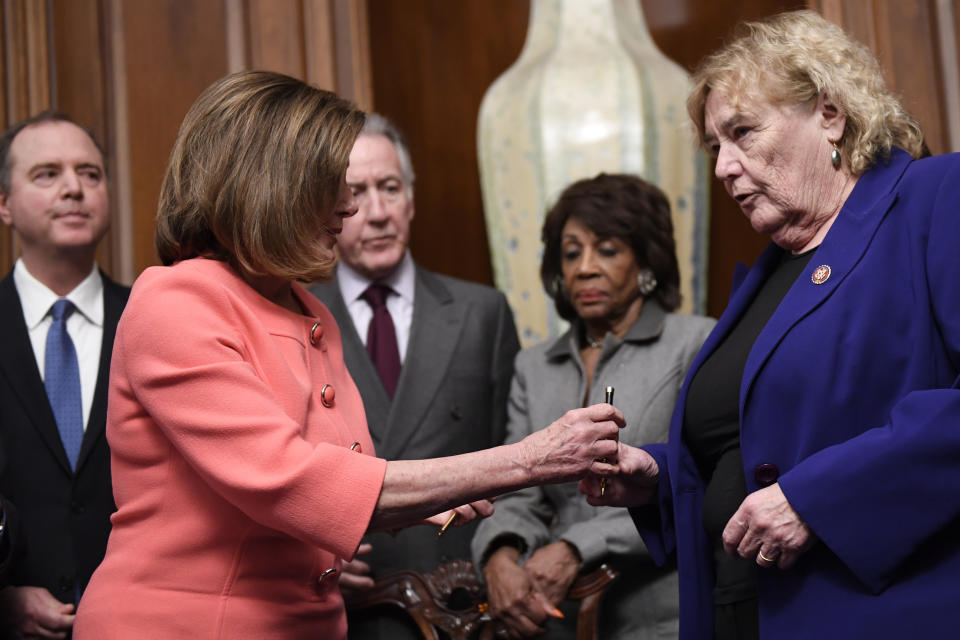 House Speaker Nancy Pelosi of Calif., second from left, gives a pen to Rep. Zoe Lofgren, D-Calif., right, after she signed the resolution to transmit the two articles of impeachment against President Donald Trump to the Senate for trial on Capitol Hill in Washington, Wednesday, Jan. 15, 2020. The two articles of impeachment against Trump are for abuse of power and obstruction of Congress. Other looking on are, from left, House Intelligence Committee Chairman Adam Schiff, D-Calif., House Ways and Means Committee Chairman Rep. Richard Neal, D-Mass., and House Financial Services Committee Chairwoman Maxine Waters, D-California. (AP Photo/Susan Walsh)