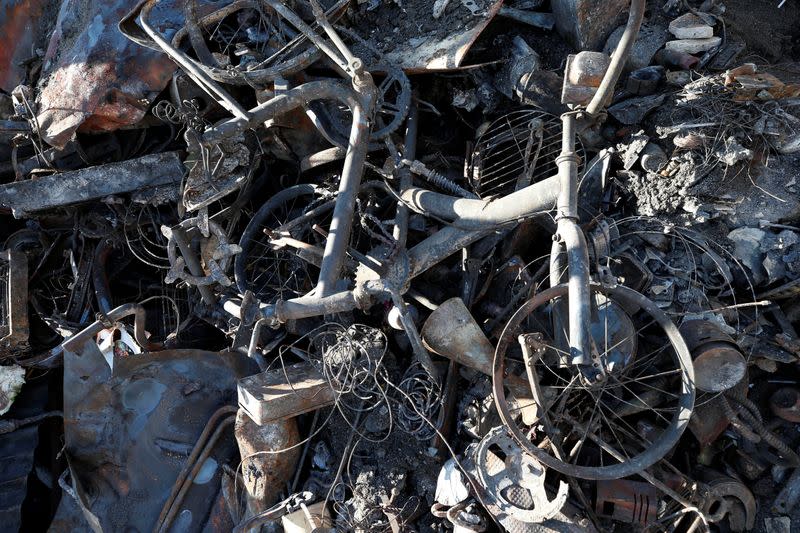 Burnt bike is seen after a fire, following the spread of wildfires in Valparaiso