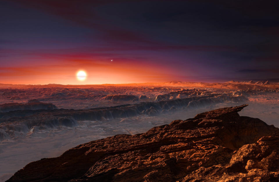 Artist impression shows a view of the surface of planet Proxima b, orbiting the red dwarf star Proxima Centauri, the closest star to our solar system. The double star Alpha Centauri can also be seen to the upper right of Proxima Centauri.