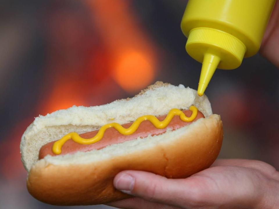 Beer, hotdogs, nachos and popcorn will be sold for $5 at Dawson's Hot Dogs stands in B.C. Place starting March 29.  (iStock/Getty Images - image credit)