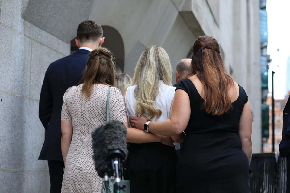 Lissie Harper (centre), the widow of Pc Andrew Harper, is supported by family and friends as she walks away (PA)