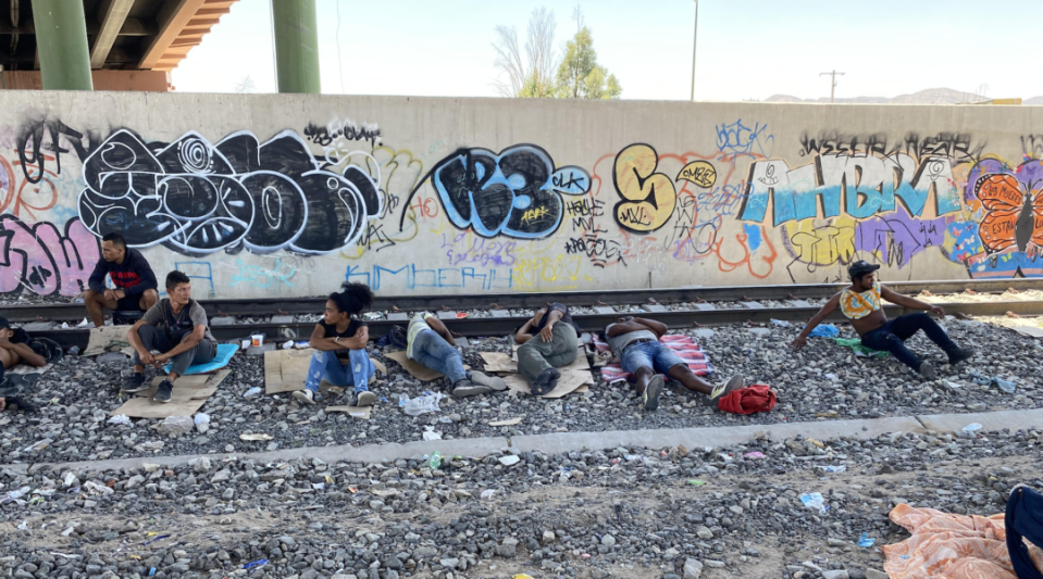 Migrants camp out by the railroad tracks near the Paso del Norte international bridge in Juárez, Mexico.