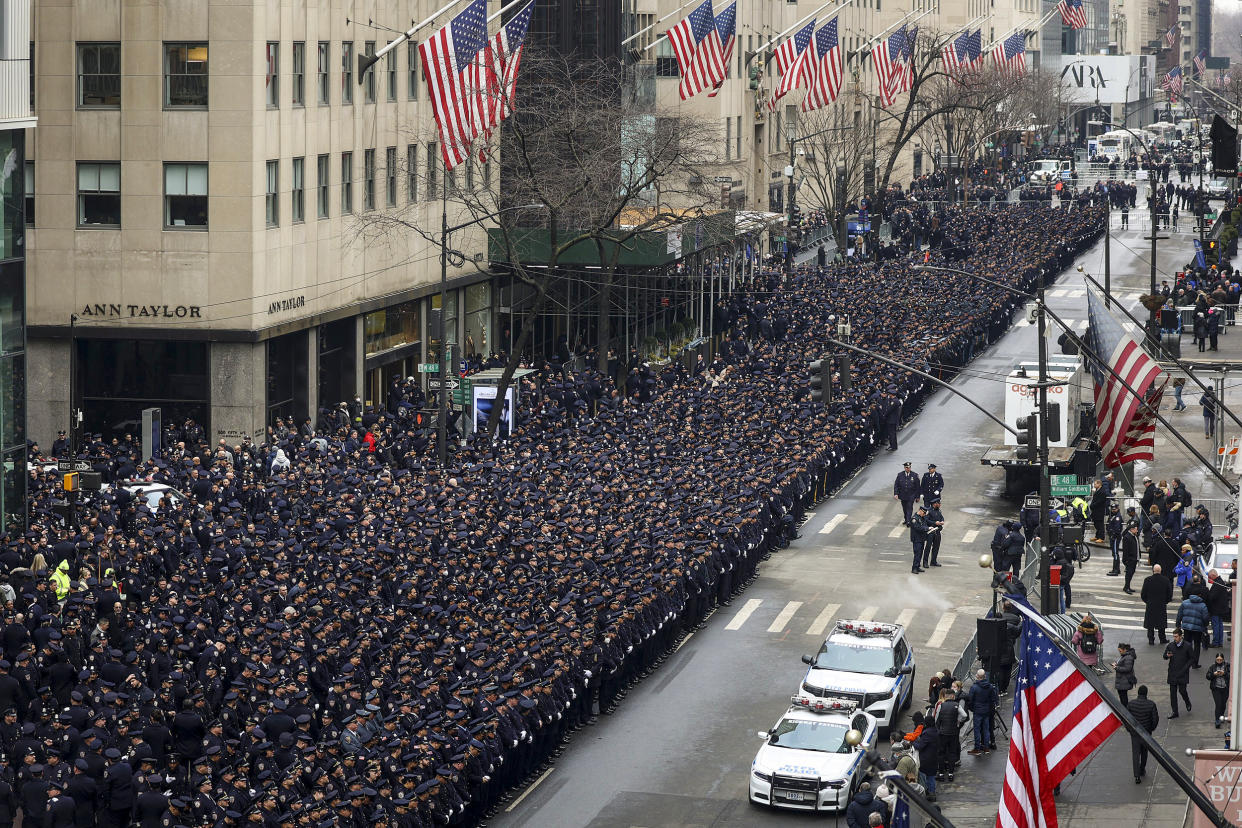 Image: New York Police officers line up along Fifth Avenue outside St. Patrick's Cathedral for Officer Wilbert Mora's funeral on Feb. 2, 2022, in New York. (Yuki Iwamura / AP)