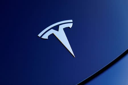 FILE PHOTO: The front hood logo on a 2018 Tesla Model 3 electric vehicle is shown in this photo illustration taken in Cardiff, California, U.S., June 1, 2018. REUTERS/Mike Blake/File Photo