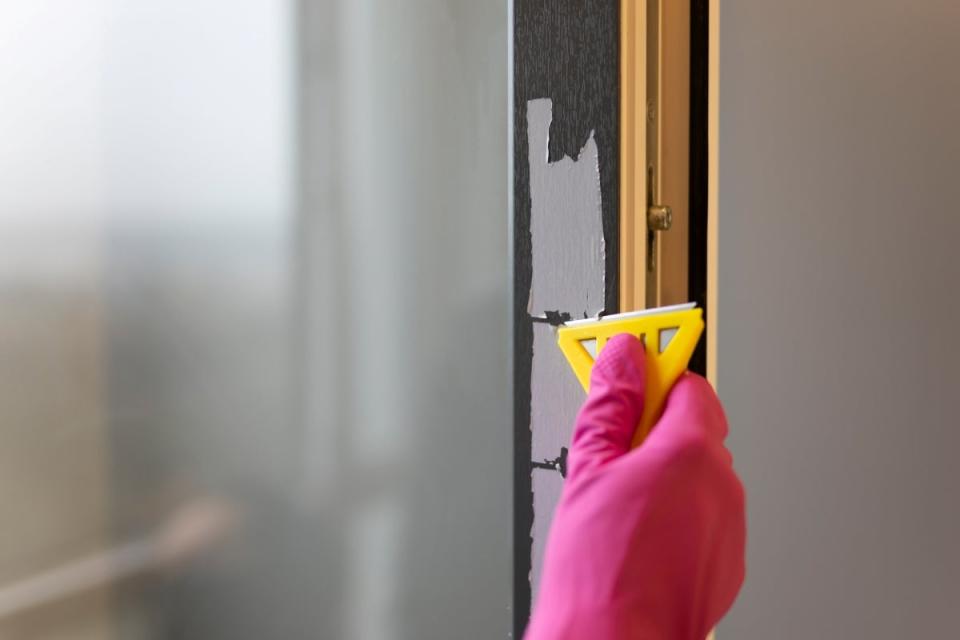 Scraping sticker from wall