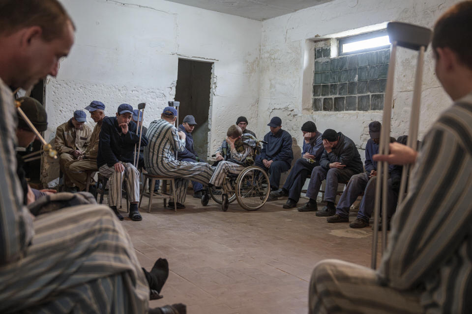Russian prisoners of war take shelter during a potential rocket attack at a detention center in Ukraine's Lviv region, Thursday, April 25, 2024. AP visited the center as part of a small group of journalists on the condition that its exact location be withheld. (AP Photo/Evgeniy Maloletka)