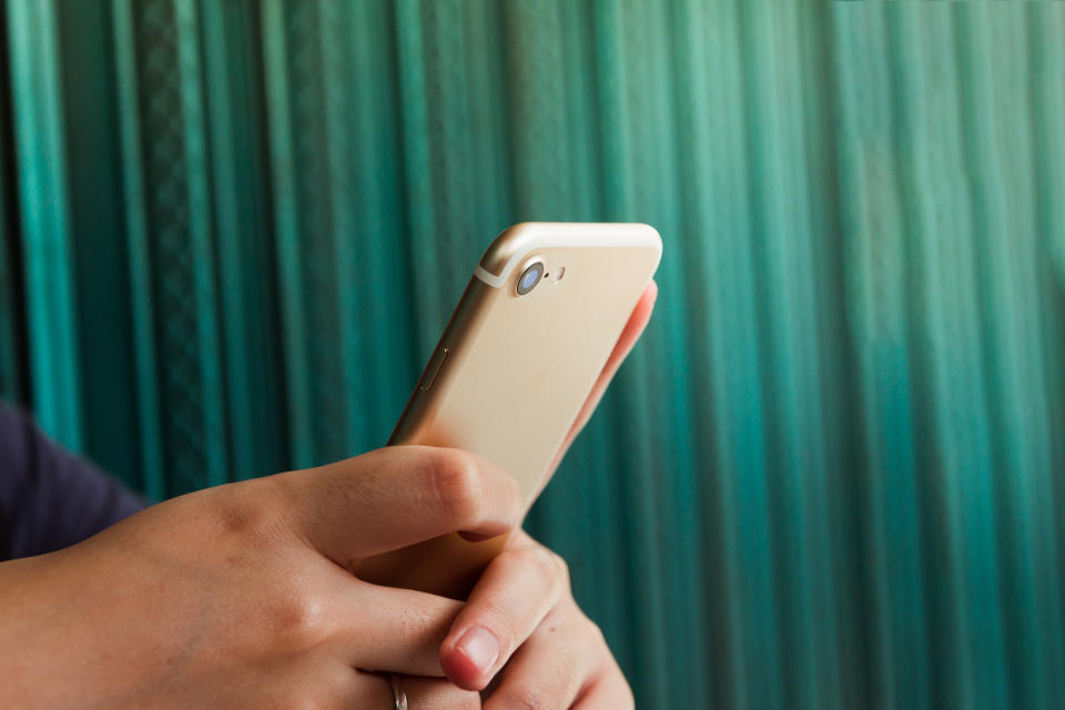 Close up hand holding smartphone. 