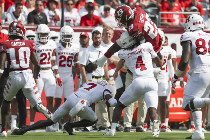 Temple running back Edward Saydee (23) attempts to hurdle over Rutgers defensive back Desmond Igbinosun (4) in the first quarter of an NCAA college football game at Lincoln Financial Field in Philadelphia, Saturday, Sept. 17, 2022. (Heather Khalifa/The Philadelphia Inquirer via AP)