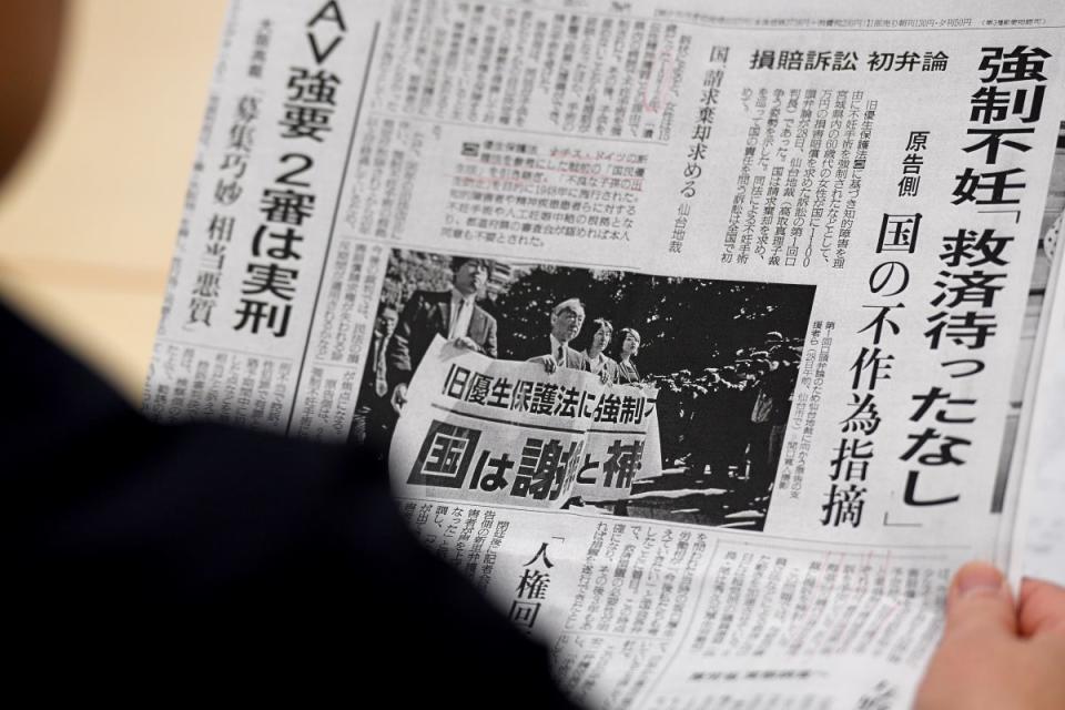 Photo from 2018 shows Michiko Sato, sister-in-law of Yumi Sato, who was sterilised as a teenager, reading a newspaper prior to a meeting with lawmakers in Tokyo (Toshifumi Kitamura/AFP via Getty Images)