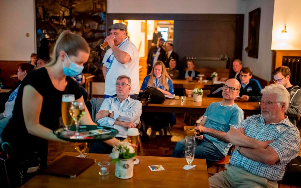 Football fans watch a game at a cafe in Berlin after lockdown measures were eased - ODD ANDERSEN/AFP