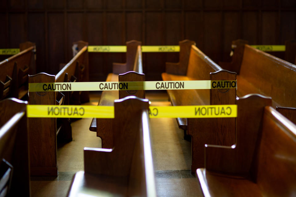 Caution tape blocks off church pews in regulation with social distancing guidelines due to Coronavirus.