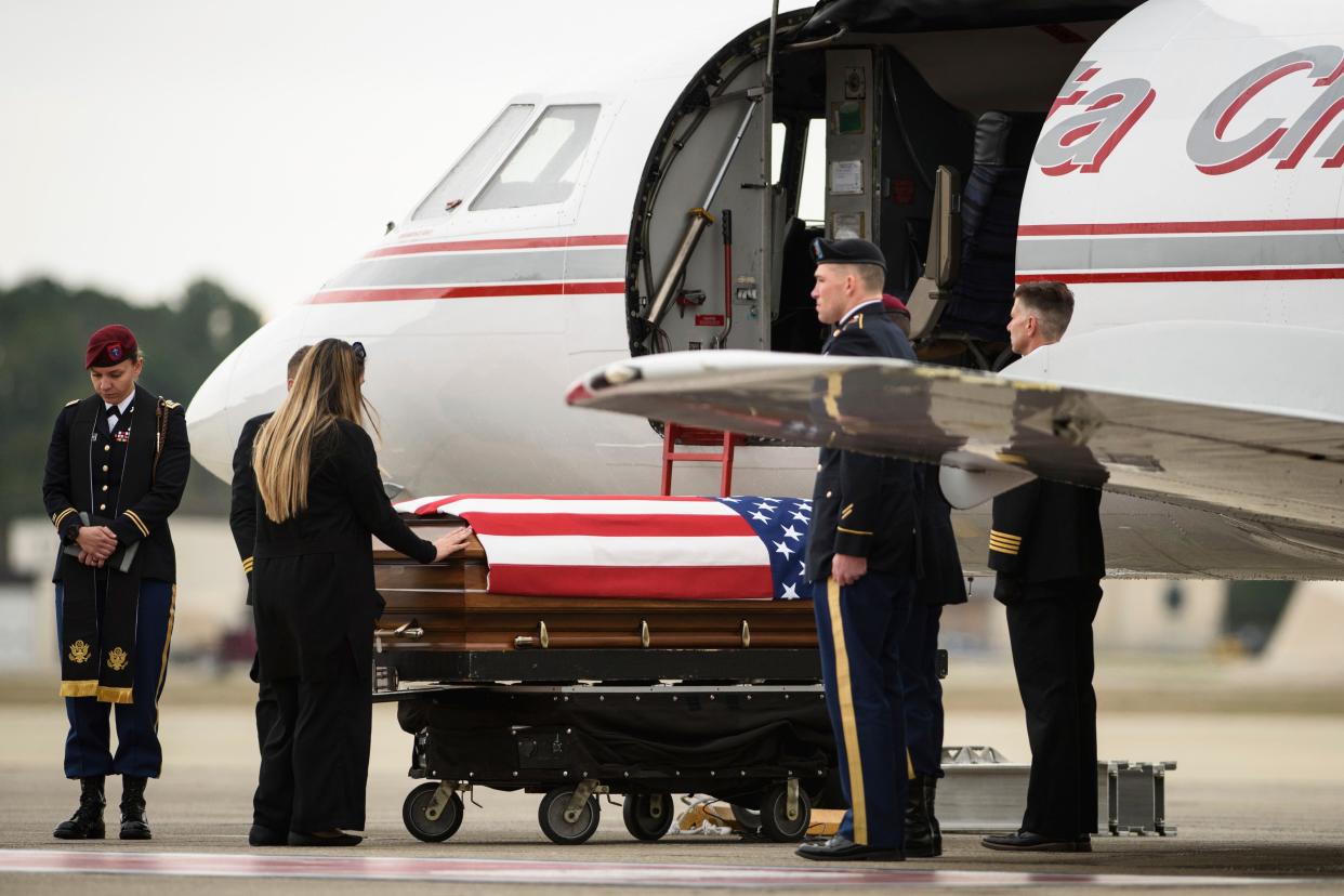 Tarah McLaughlin, the widow of Staff Sgt. Ian Paul McLaughlin, touches her husband's coffin on Saturday, Jan. 18, 2020, on Fort Bragg, N.C. McLaughlin was killed Jan. 11 in Afghanistan.
