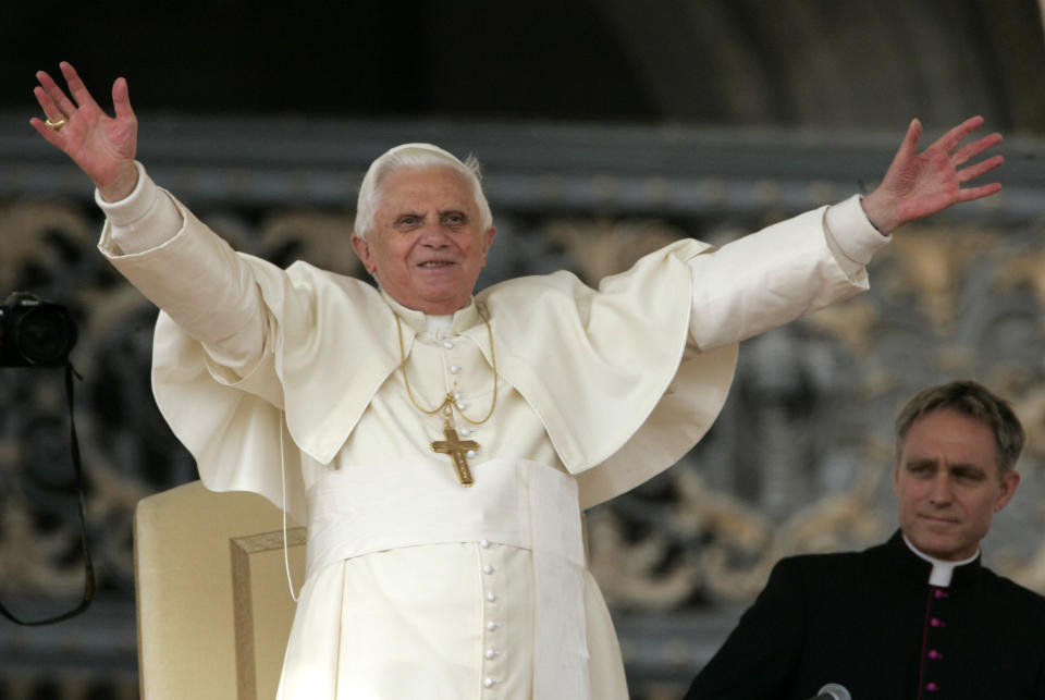 FILE -Pope Benedict XVI acknowledges cheers from faithful and pilgrims during the weekly general audience in St. Peter's square at the Vatican, Wednesday, Oct.24, 2007. At right is the Pope's personal secretary Georg Genswein. Retired Pope Benedict XVI has corrected an assertion that he didn’t attend a 1980 meeting at which the transfer of a pedophile priest to his then-diocese was discussed. His secretary says an editorial error was responsible for the claim that the authors of a report on sexual abuse said lacked credibility. (AP Photo/Plinio Lepri,file)