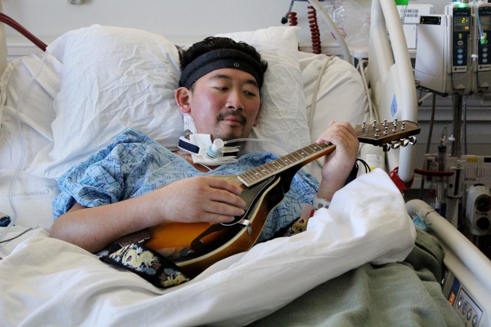 Kyle Park plays the mandolin to keep his spirits high while at Willis-Knighton Medical Center as he waits to be transported to San Diego for a lung transplant Sunday afternoon, November 7, 2021.