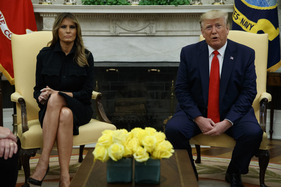 First lady Melania Trump listens as President Donald Trump talks about a plan to ban most flavored e-cigarettes, in the Oval Office of the White House, Wednesday, Sept. 11, 2019, in Washington. (AP Photo/Evan Vucci)