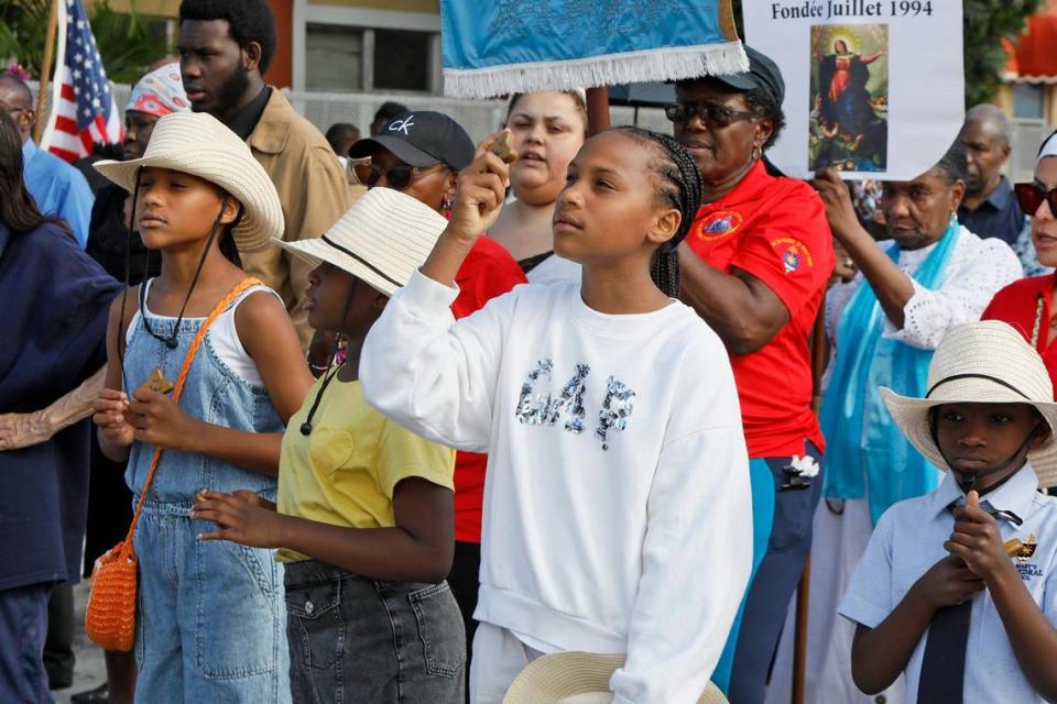 Su Maya Brewster 10; Summer Brewster 10; Aiyanna Antenor, 9 and Ayden Alexander 7 walk during the Veneration of the Cross procession at The Cathedral of St. Mary.